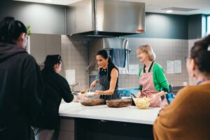 Meghan, Duchess of Sussex and McAuley CEO, Jocelyn Bignold serve lunch at McAuley House.